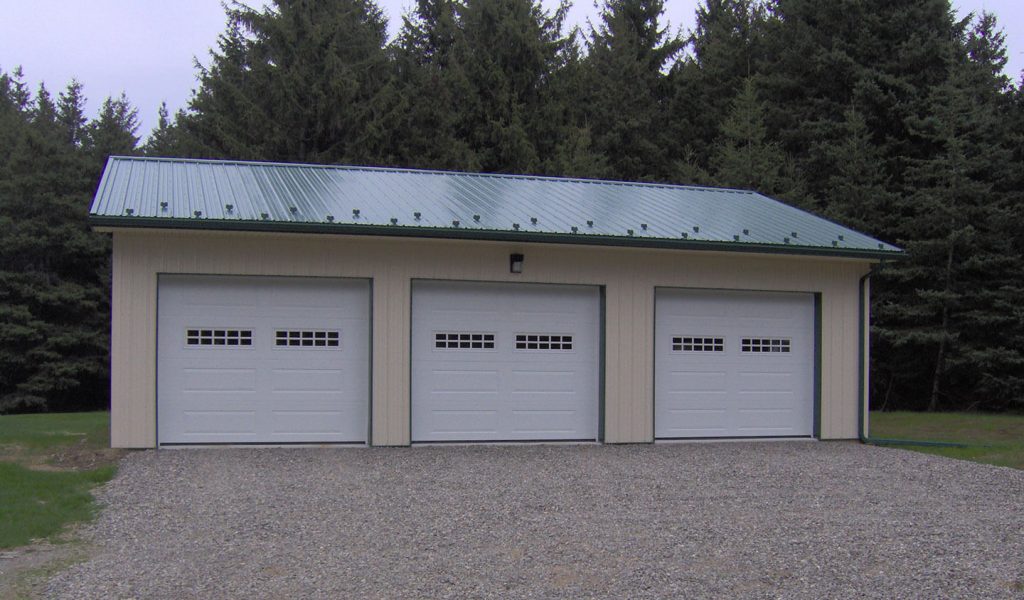 Tan garage with green roof